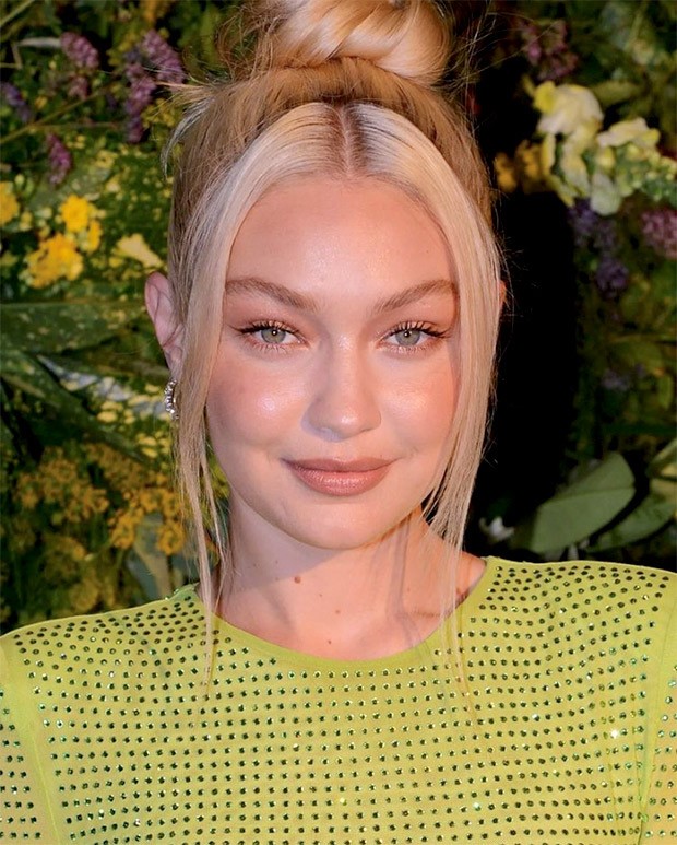 Gigi Hadid amps up the glamor in a green body-con dress for British Vogue X Self Portrait's summer party in London